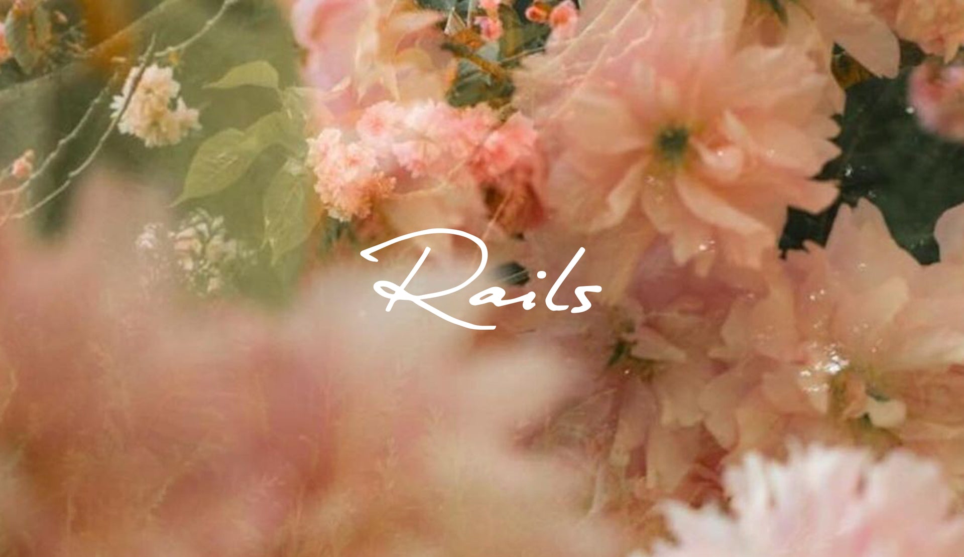 IMAGE OF PINK FLOWERS WITH RAILS WRITTEN ACROSS THE FRONT IN WHITE FONT
