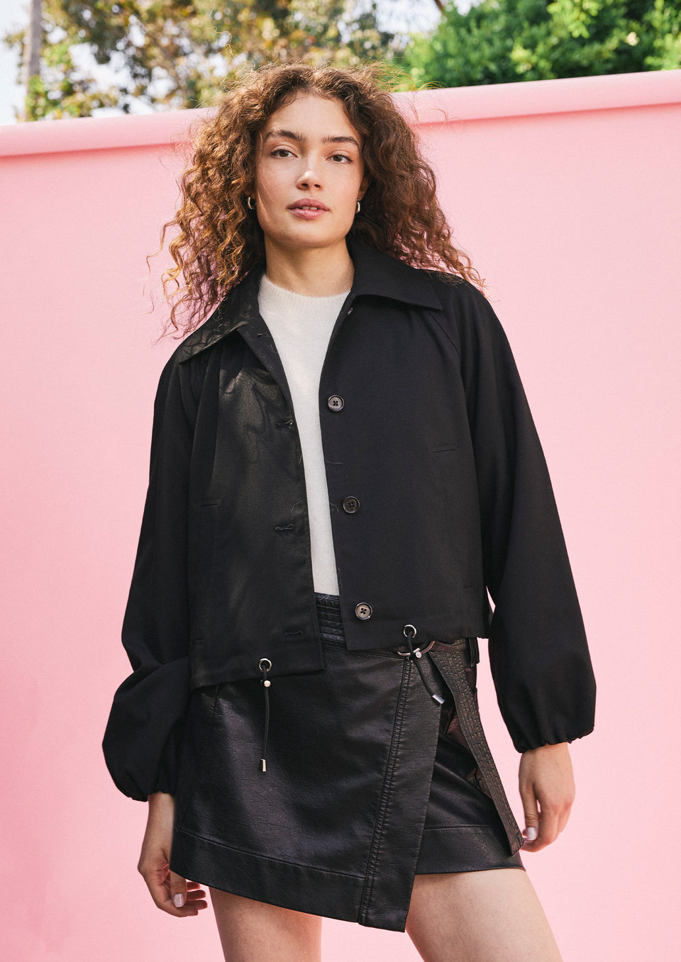 EDITORIAL IMAGE OF MODEL WEARING NORTH JACKET, BRIAR TOP, AND ADRIANA SKIRT