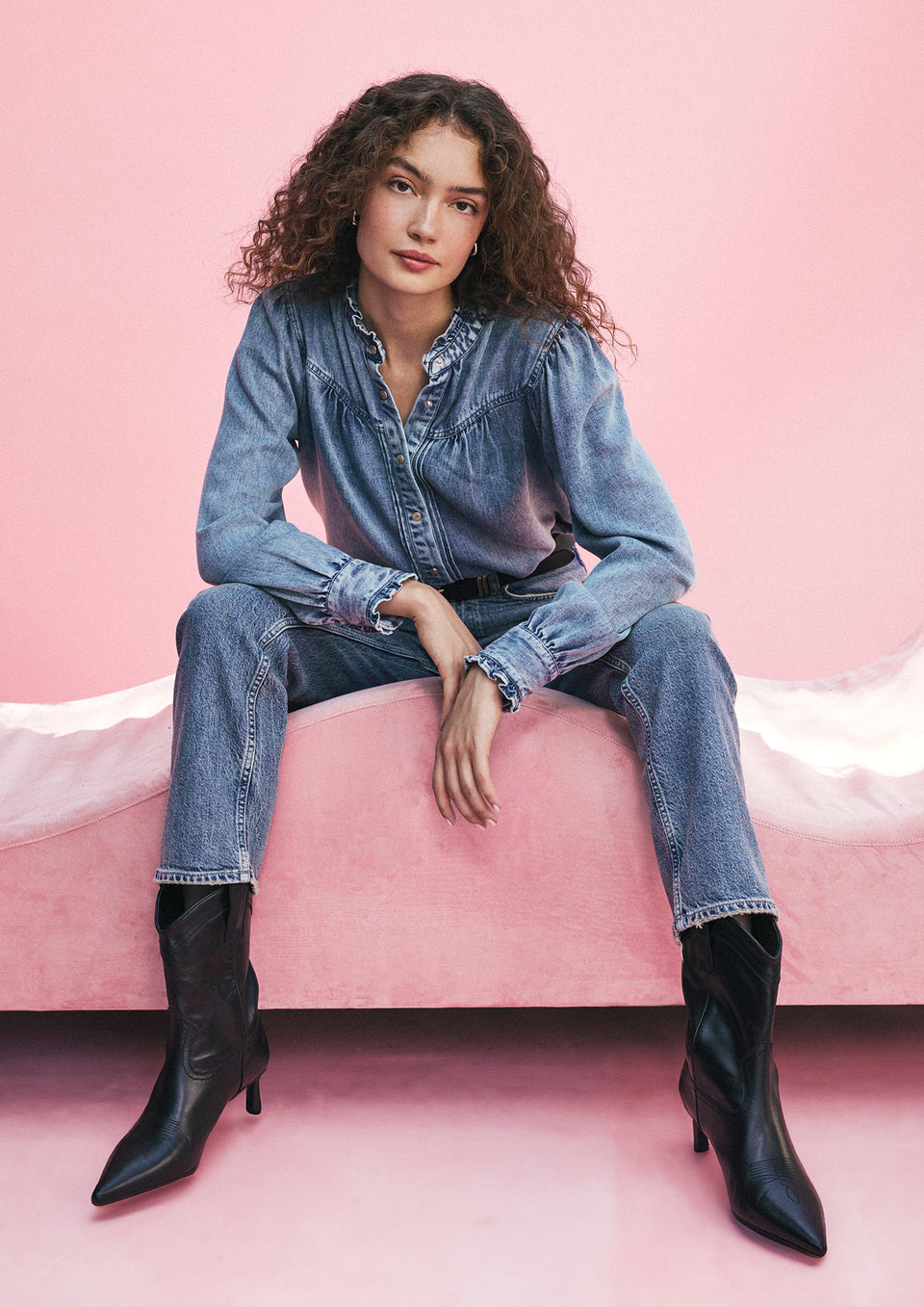 EDITORIAL IMAGE OF MODEL SITTING WEARING ALANNA TOP AND TOPANGA STRAIGHT JEANS