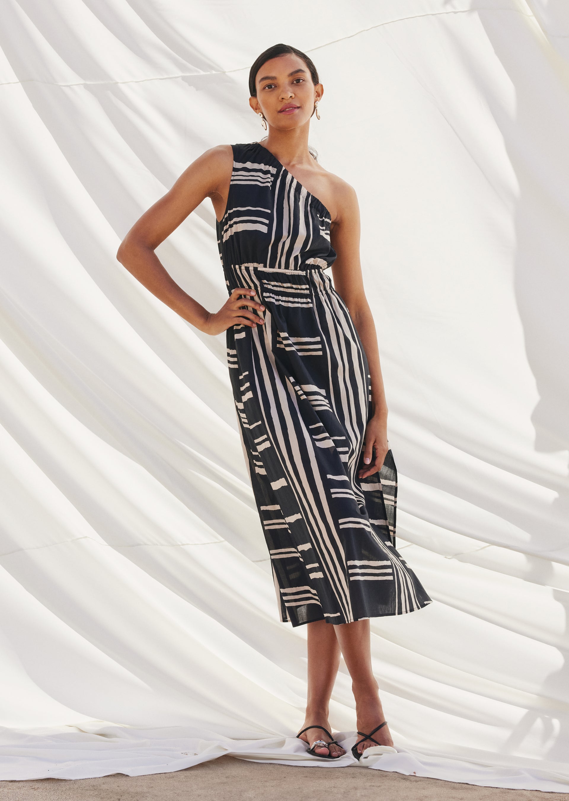 FRONT FULL BODY EDITORIAL IMAGE OF MODEL WEARING SELANI DRESS IN ISLAND STRIPE