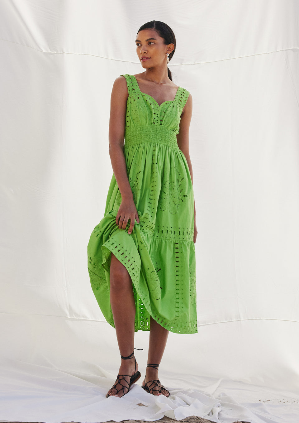 FRONT FULL BODY EDITORIAL IMAGE OF MODEL WEARING FAWN DRESS IN ISLAND GREEN