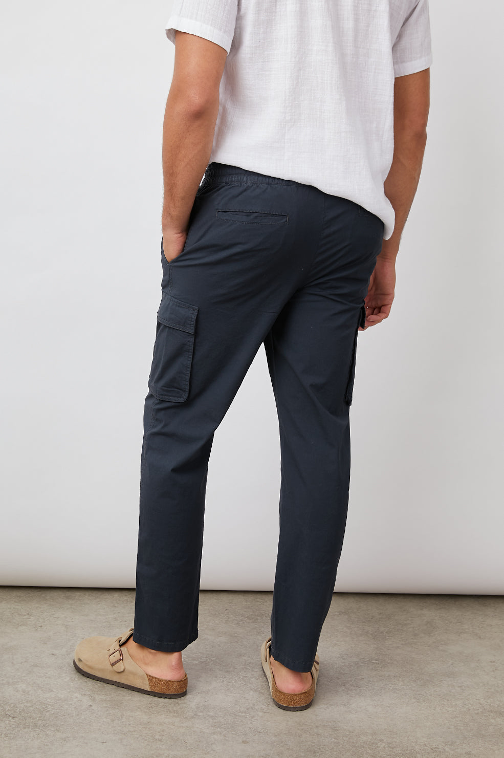 Emmerson Pants with a Drawstring Waist, Two Front Pockets, Two Side Flap Pockets and Two Back Welt Pockets in Washed Black Colorway - Back View Featured on Model