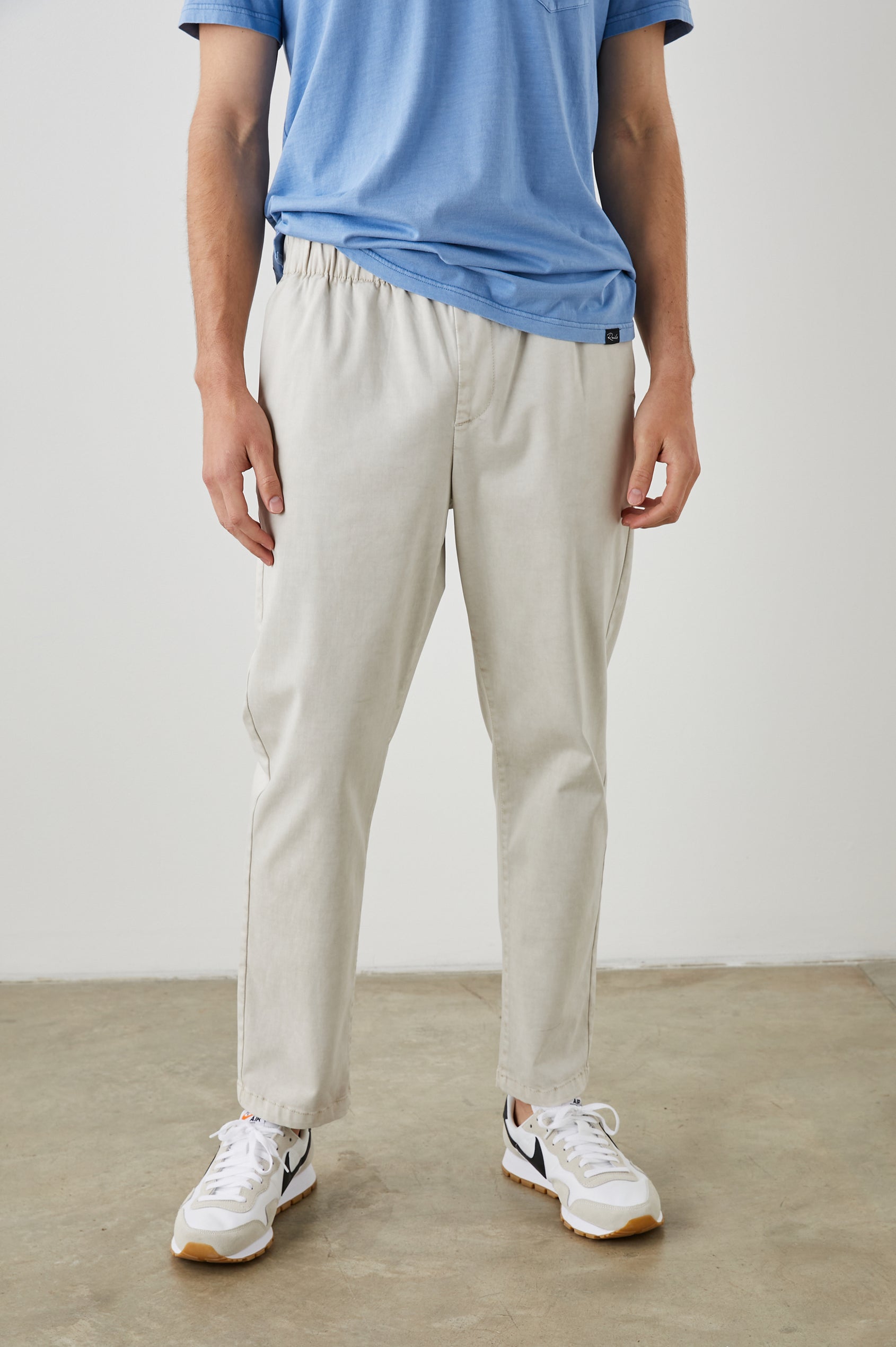 Julian Pants with an Elastic Waist, Two Front Pockets and Two Back Welt Pockets in Natural Colorway - Front View Featured on Model 