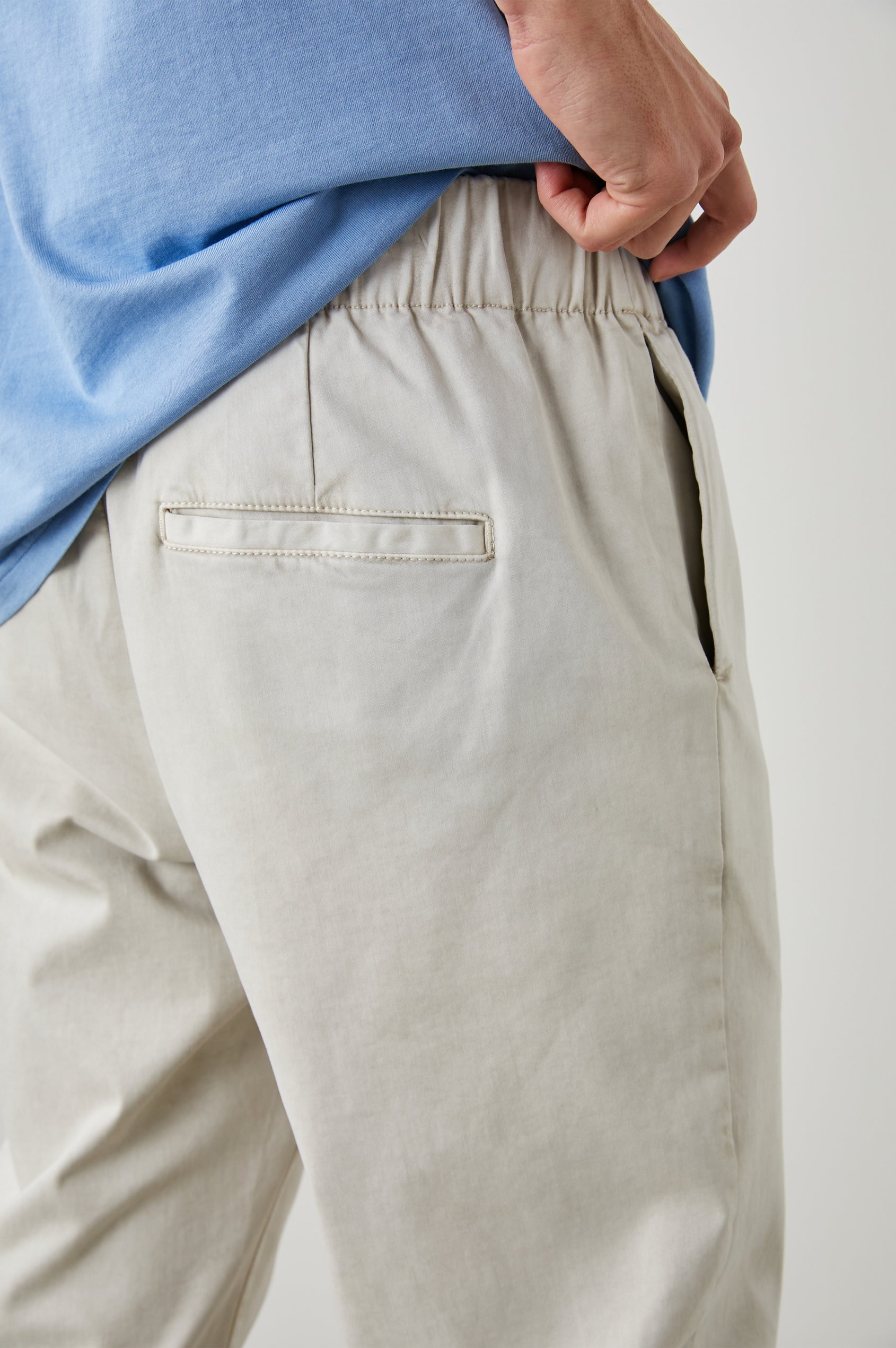 Julian Pants with an Elastic Waist, Two Front Pockets and Two Back Welt Pockets in Natural Colorway - Back View Featured on Model 
