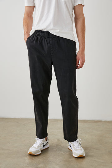  Julian Pants with an Elastic Waist, Two Front Pockets and Two Back Welt Pockets in Washed Black Colorway - Front View Featured on Model 