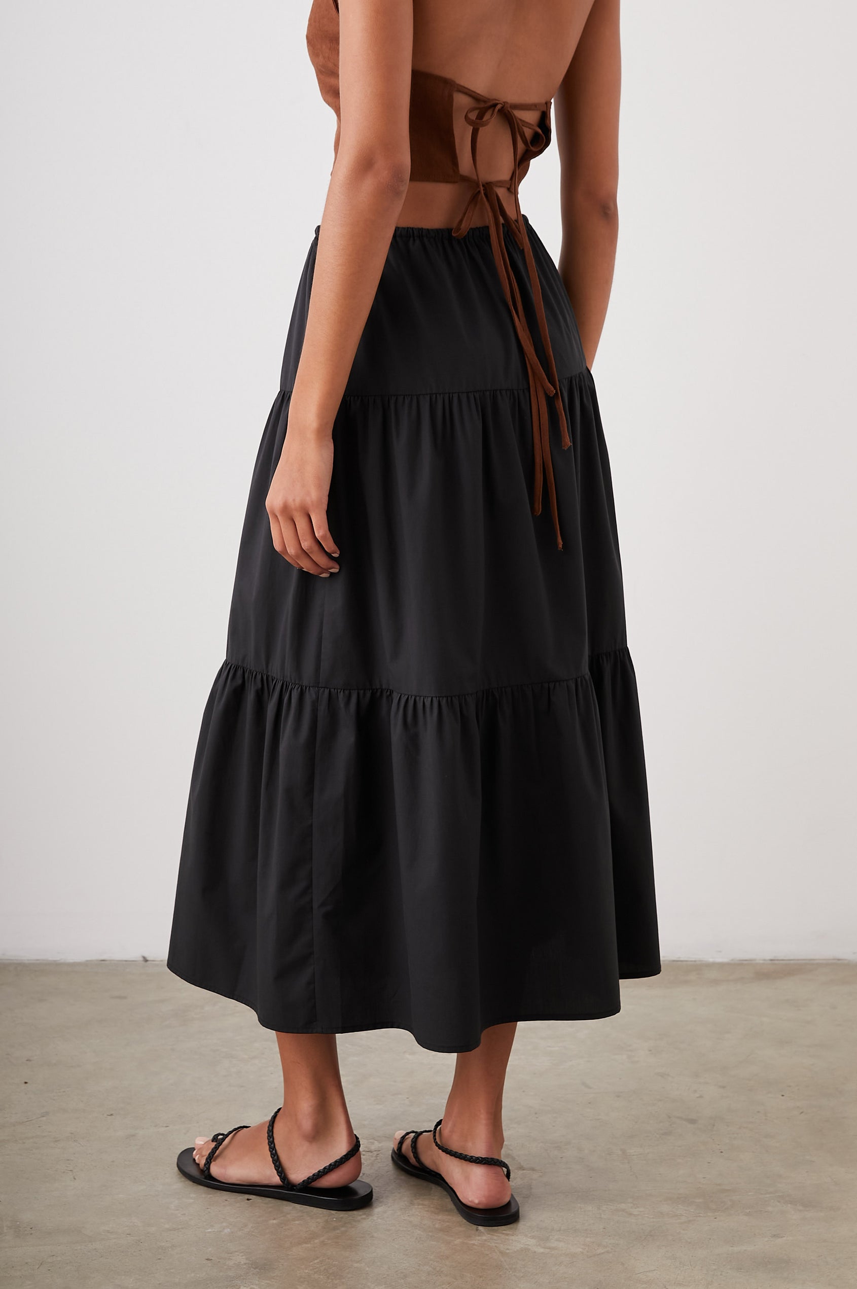 Mary Tiered Midi Skirt with a Drawstring Waist in Black Colorway - Back View Featured on Model