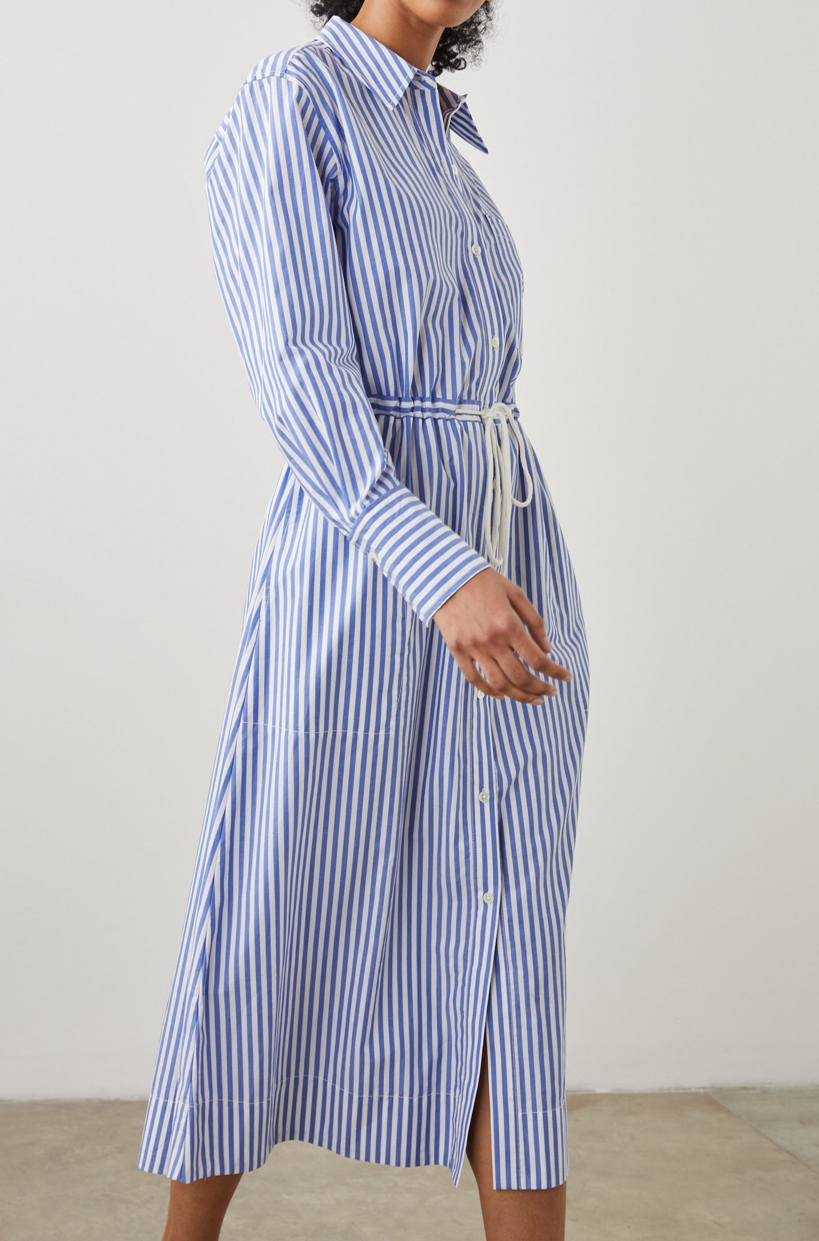 Shivonne Long-Sleeve Midi Dress with a Full Button Front, a Collar and a Drawcord Waist in Rivera Stripe Colorway, Blue and White Vertical Stripes - Side Full Body View Featured on Model