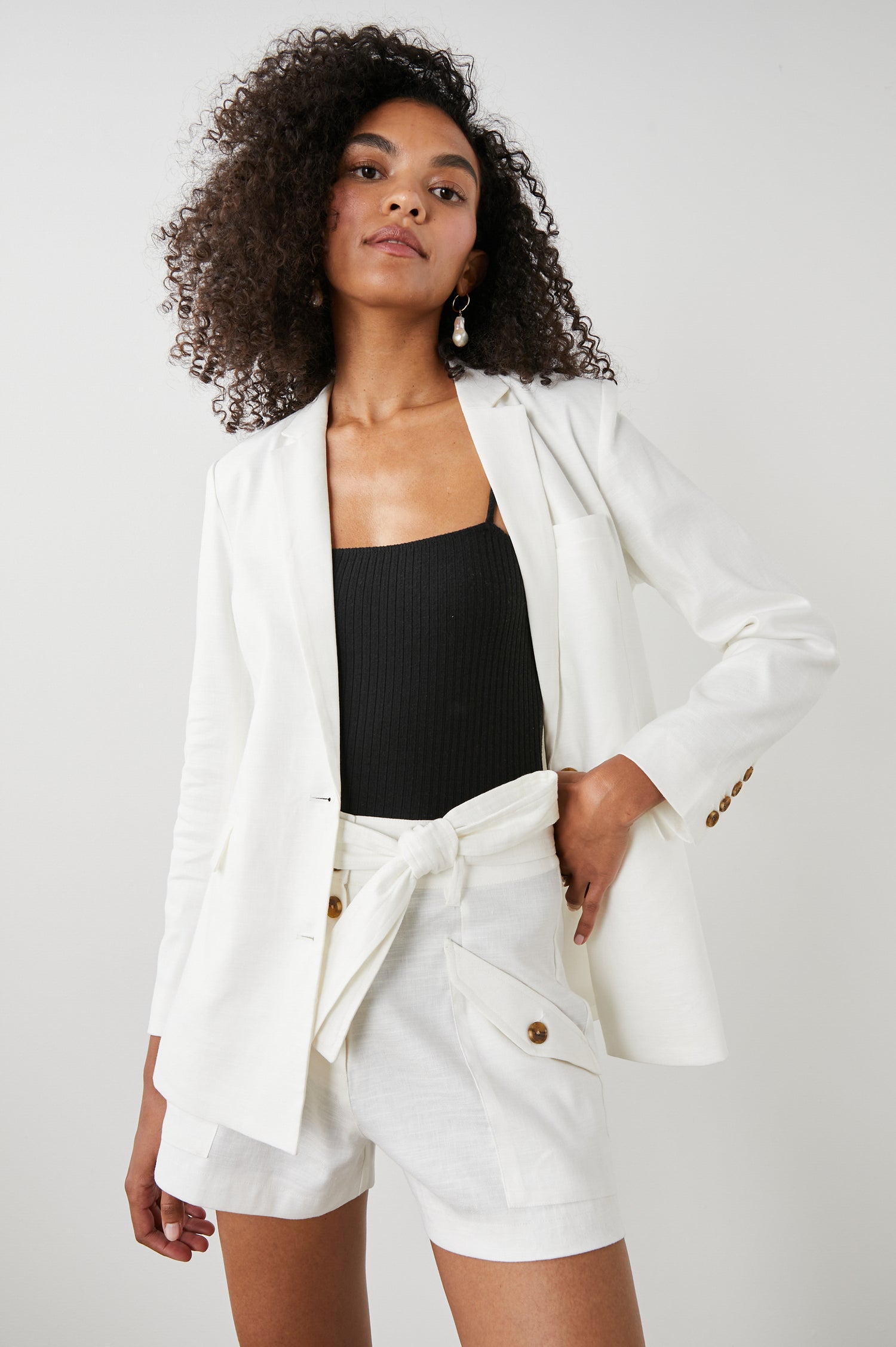 Stanton Blazer with Two Button Closure, Two Front Flap Pockets, a Chest Patch Pocket and Four-Button Cuffs in Creme Colorway - Front View Featured on Model