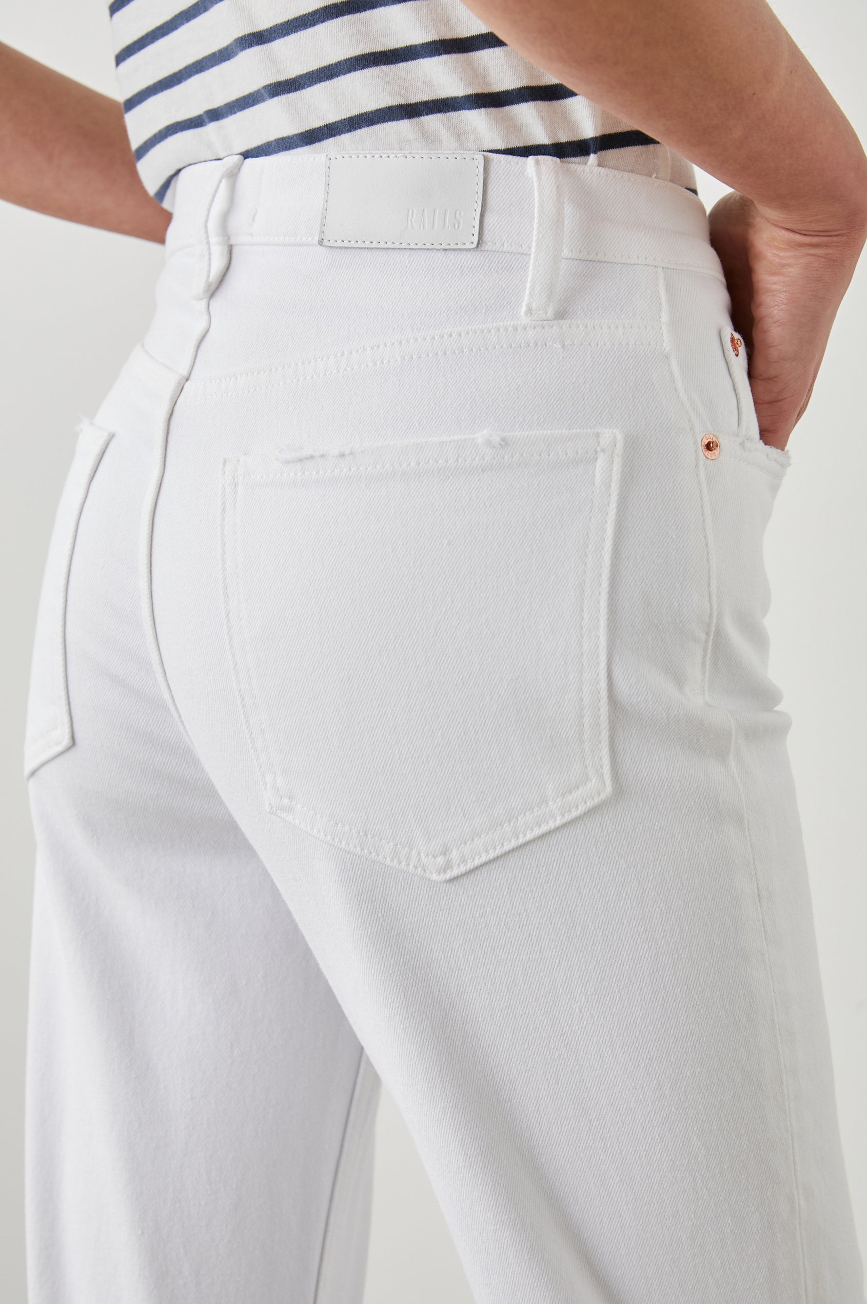 Topanga Straight Jeans with a Hole at the Knee and Fraying, Belt Loops, Two Front Pockets plus a Coin Pocket and Two Back Patch Pockets in Salt White Distress Colorway - Back View Featured on Model