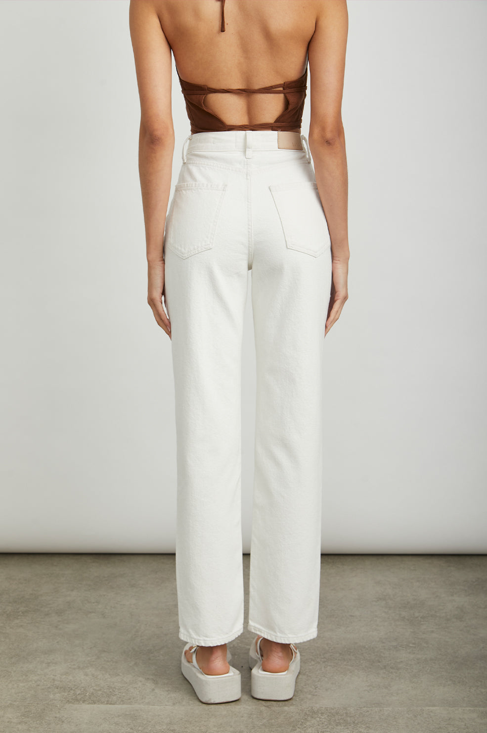 Topanga Straight Jeans with a Hole at the Knee and Fraying, Belt Loops, Two Front Pockets plus a Coin Pocket and Two Back Patch Pockets in Salt White Distress Colorway - Back View Featured on Model